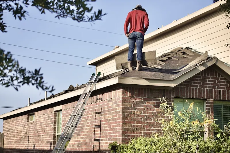 Professional roofer working on a residential roof in Ebro
